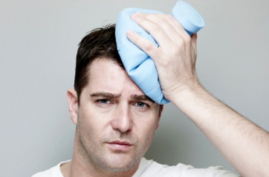Man Holding Ice Pack On Head.